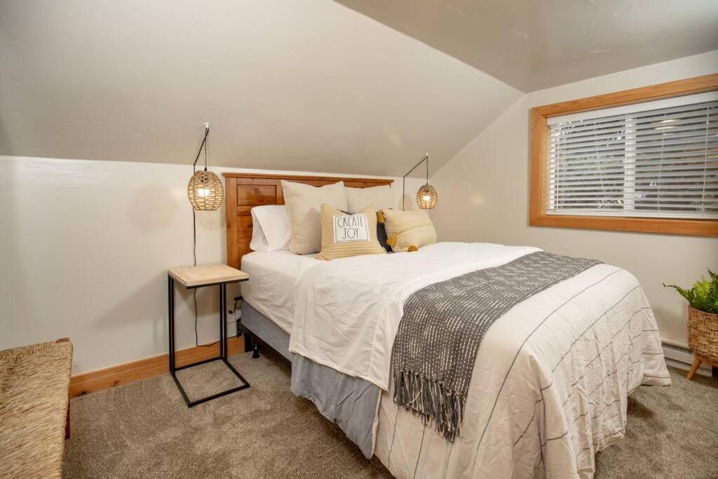 a bedroom with a large bed and a window at Afton Farmhouse with Mountain Views in Afton