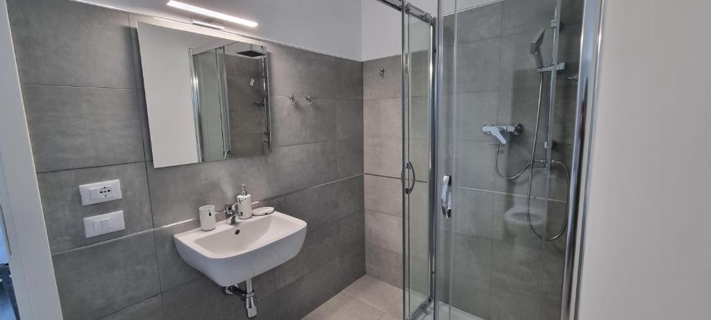 a bathroom with a sink and a glass shower at Residenza Margot in Quattromiglio