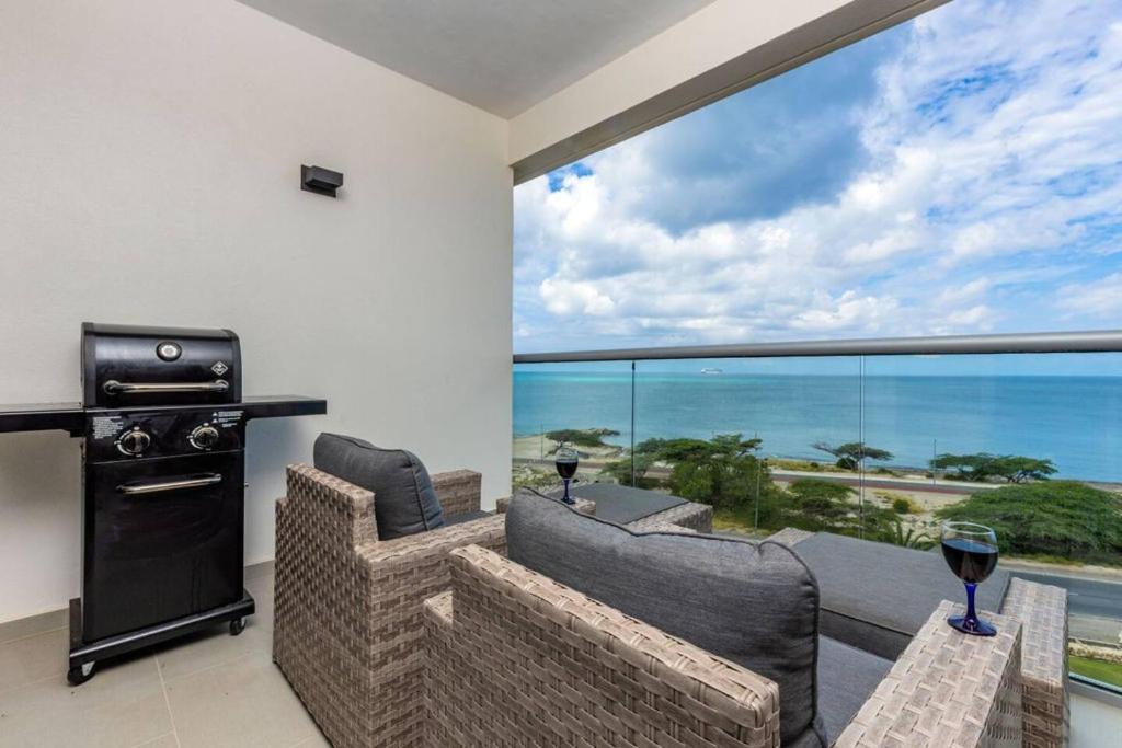 a living room with a view of the ocean at Breath Taking Beach Front Views Condo Eagle Beach in Palm-Eagle Beach