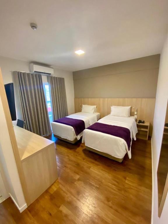 Postel nebo postele na pokoji v ubytování Legacy Hotel Guaratinguetá - Ao lado de Aparecida -SP