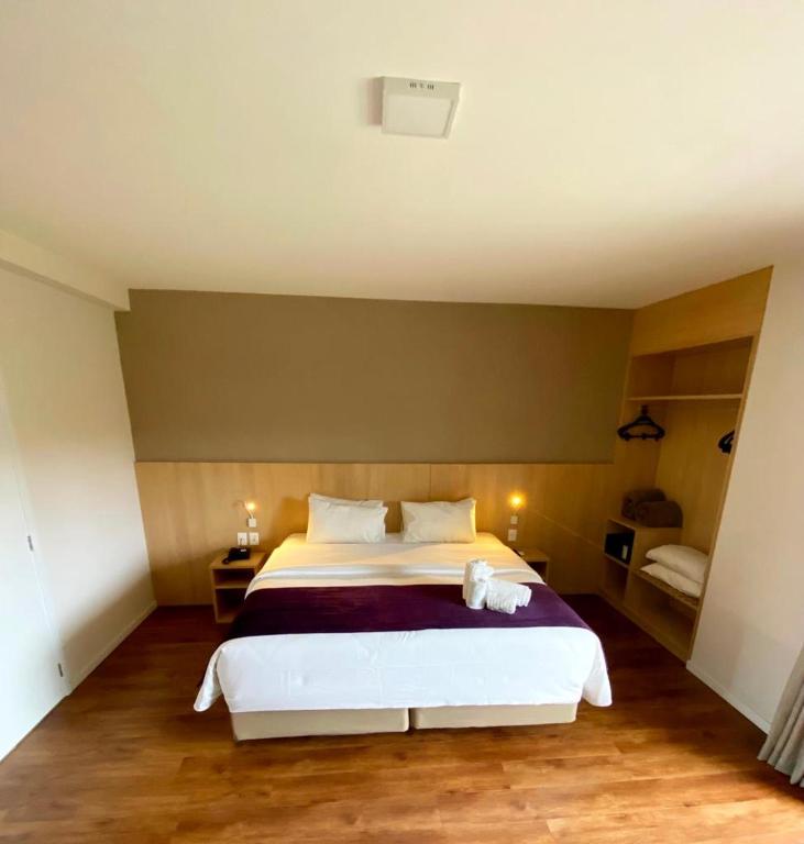 Postel nebo postele na pokoji v ubytování Legacy Hotel Guaratinguetá - Ao lado de Aparecida -SP