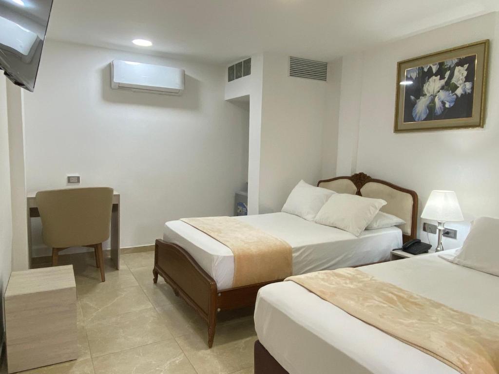 Postel nebo postele na pokoji v ubytování Hotel Casa Colonial