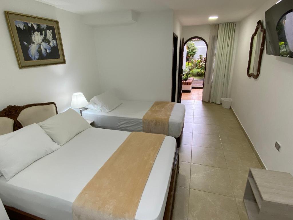 Postel nebo postele na pokoji v ubytování Hotel Casa Colonial