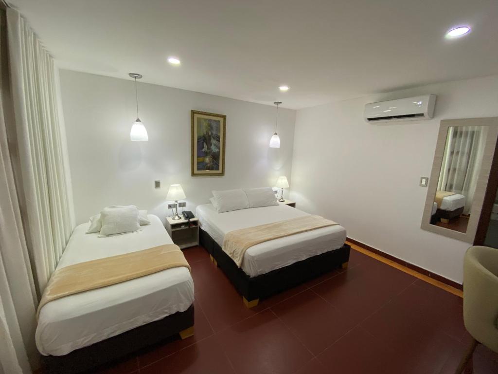 Postel nebo postele na pokoji v ubytování Hotel Casa Colonial