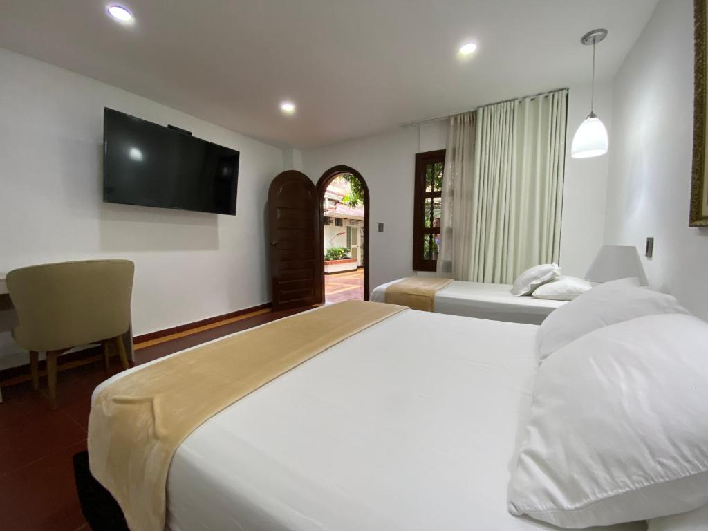 Postel nebo postele na pokoji v ubytování Hotel Casa Colonial