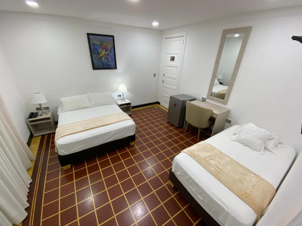 Postel nebo postele na pokoji v ubytování Hotel Casa Colonial