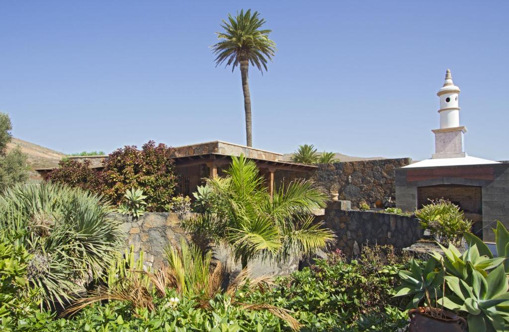 a church with a palm tree and a lighthouse at Villa Remedios in Teguise