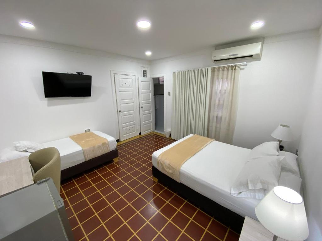 Postel nebo postele na pokoji v ubytování Hotel Casa Colonial