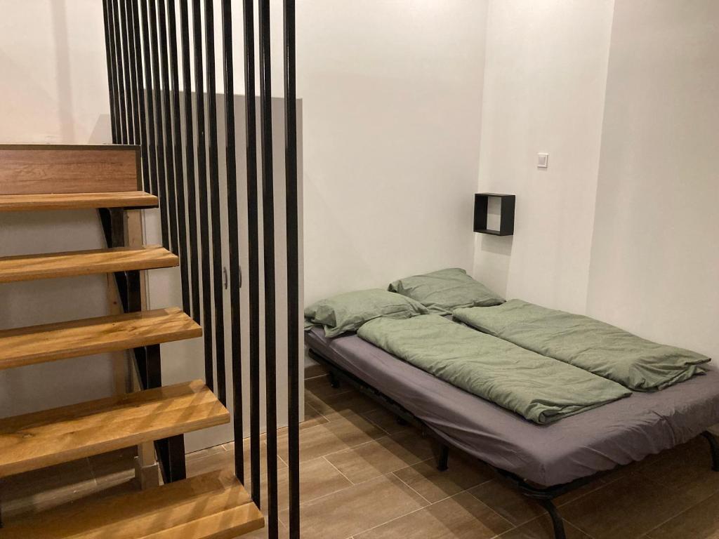 a small bedroom with a bed in a room at Roland Apartment Downtown - Keleti in Budapest