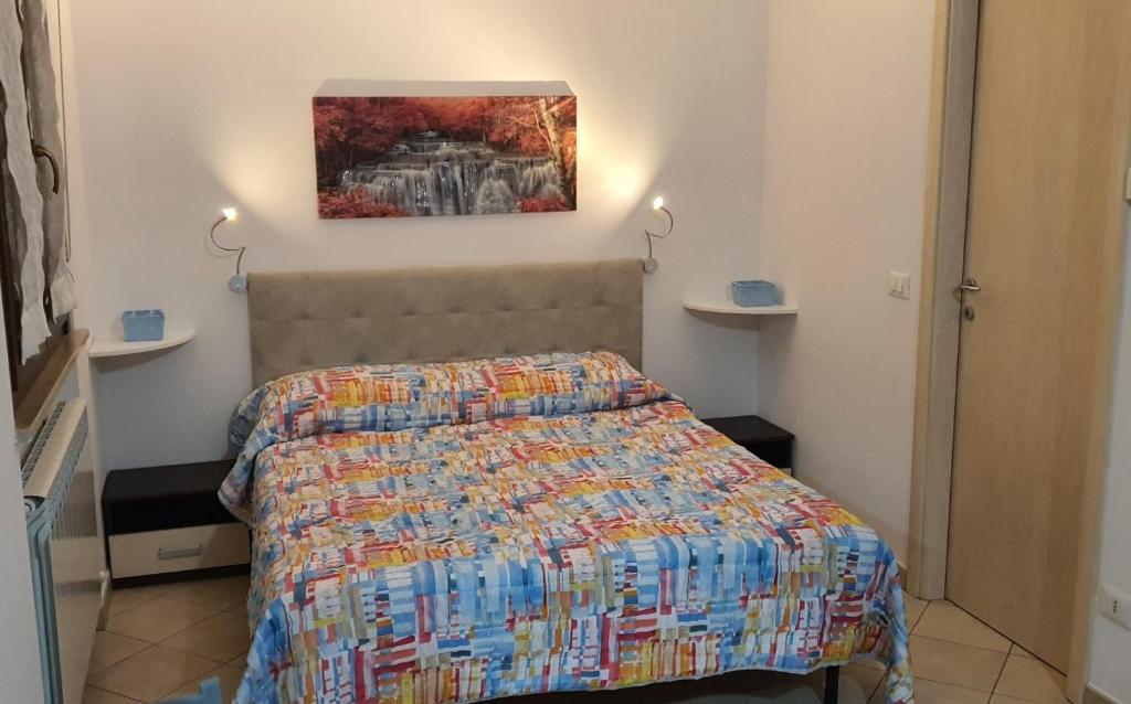 una camera da letto con un letto e un dipinto sul muro di Sweet Home a Chiaravalle