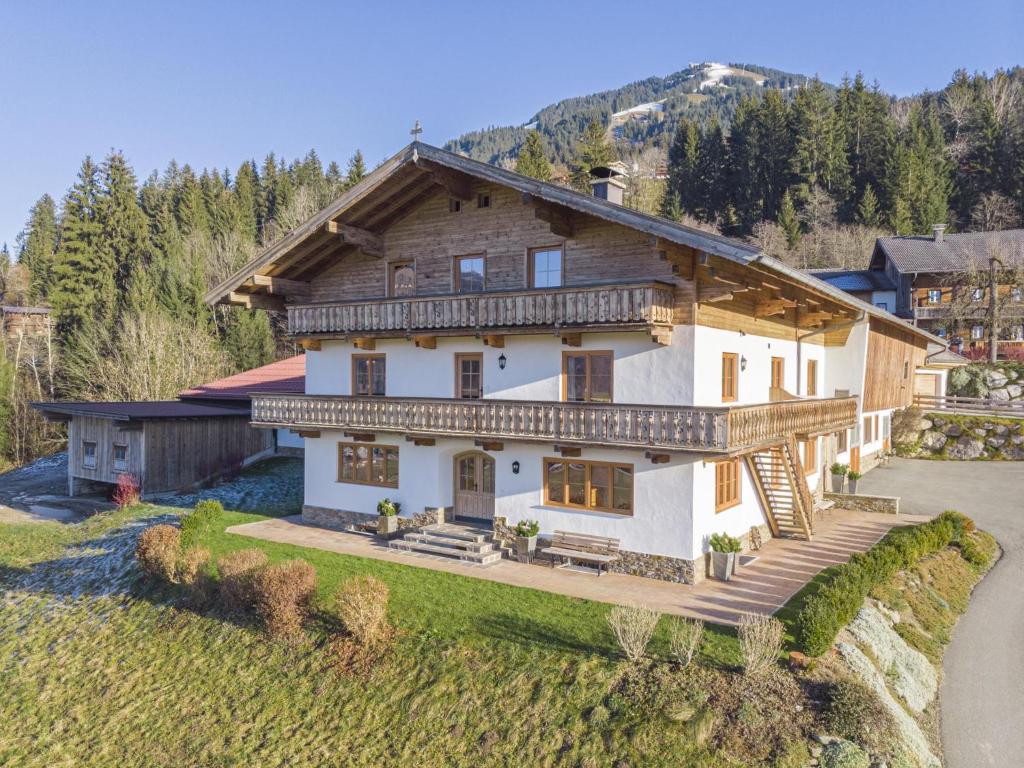 a large white house with a wooden roof at Glonersbühelhof Top 1 in Westendorf