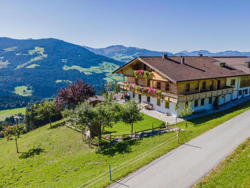 a house on top of a hill with a road at Igl Hof Top 3 in Westendorf