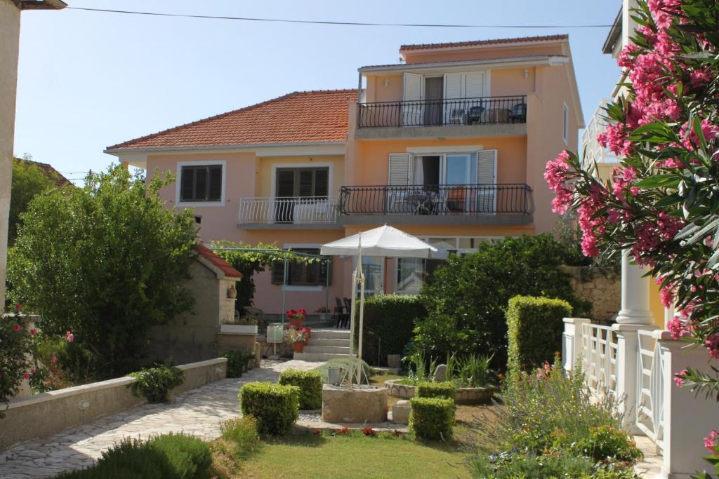 a house with a garden in front of it at Triple Room Pasman 8223e in Pašman