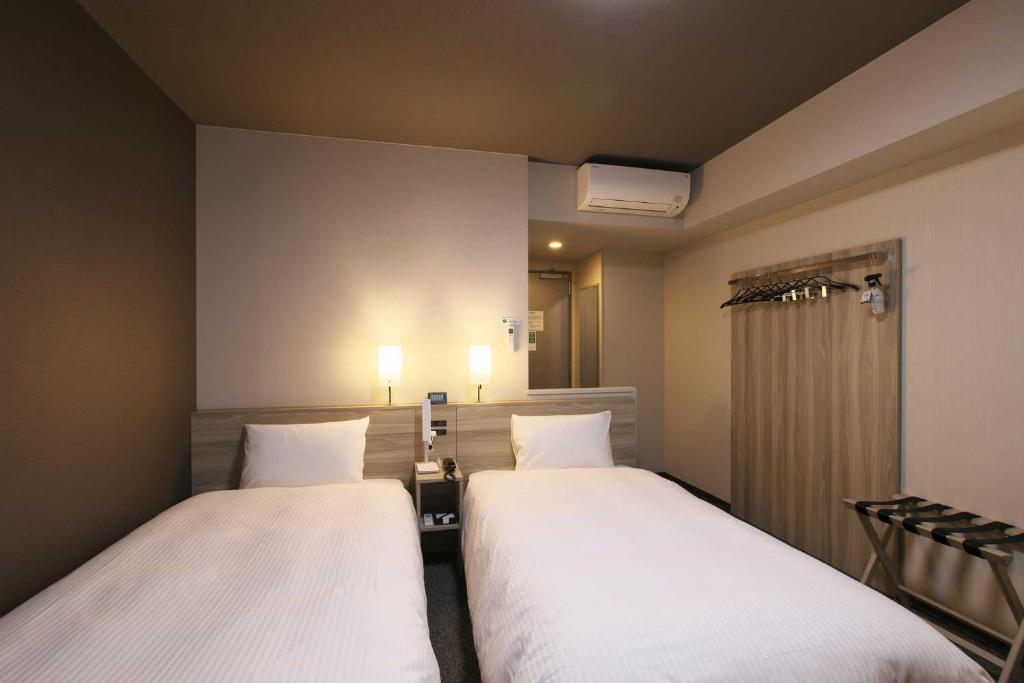Postel nebo postele na pokoji v ubytování Hotel Route Inn Mitsuke -Nakanoshima Mitsuke Inter-