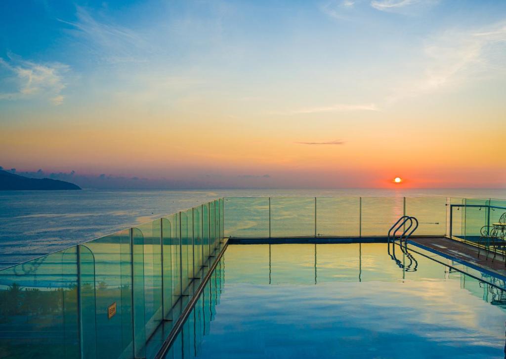 ein Pool auf einem Kreuzfahrtschiff bei Sonnenuntergang in der Unterkunft Alani Hotel & Spa in Đà Nẵng