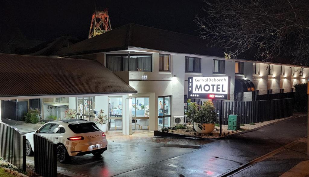 a car parked in a parking lot in front of a motel at Central Deborah Motel in Bendigo