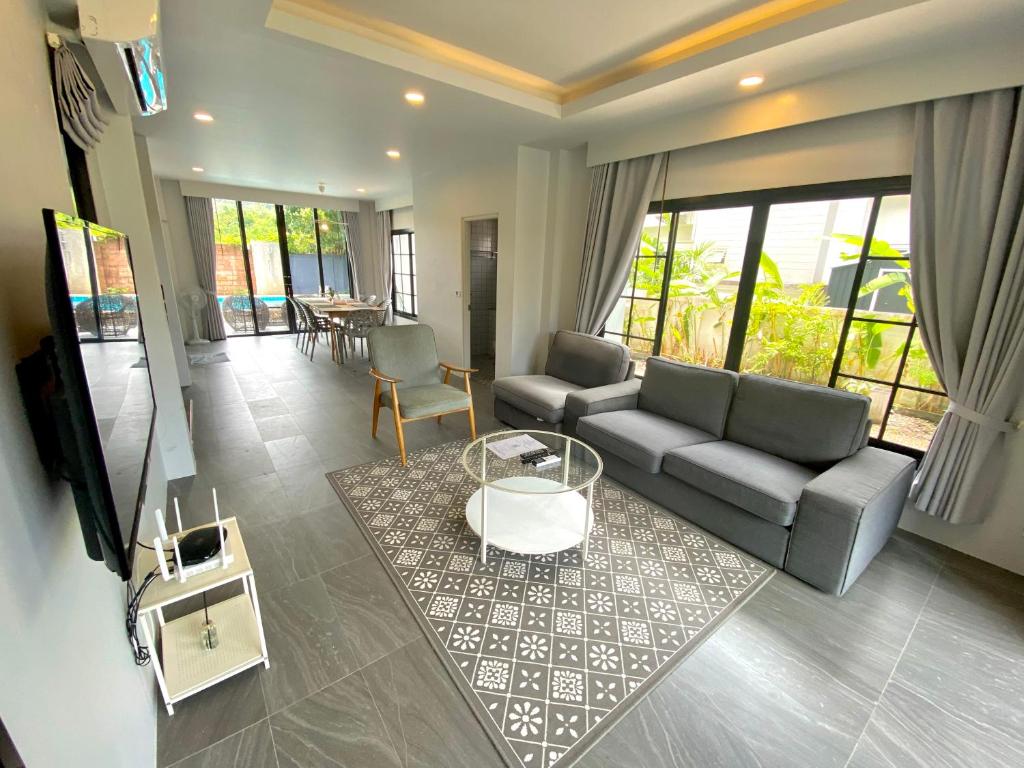 a living room with a couch and a table at The Retreat Ao nang Private Pool Villa in Ao Nang Beach