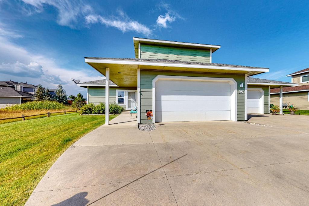 a house with a white garage door on a driveway at High Country Haven in Pagosa Springs