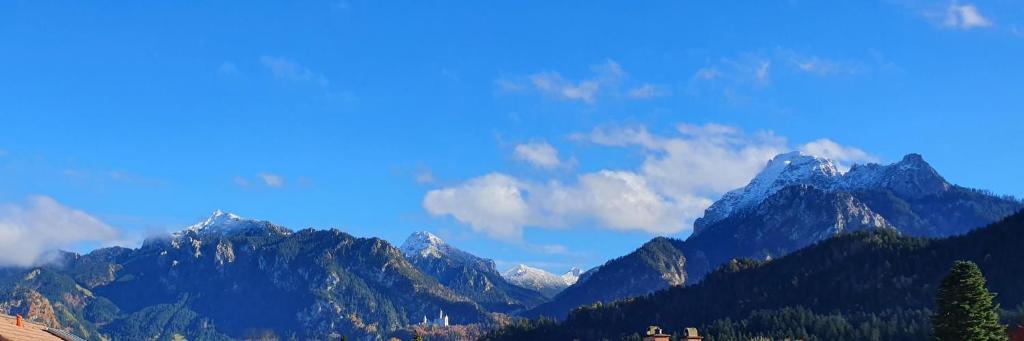 a view of a mountain range with snow capped mountains at Panorama Apartments in Füssen
