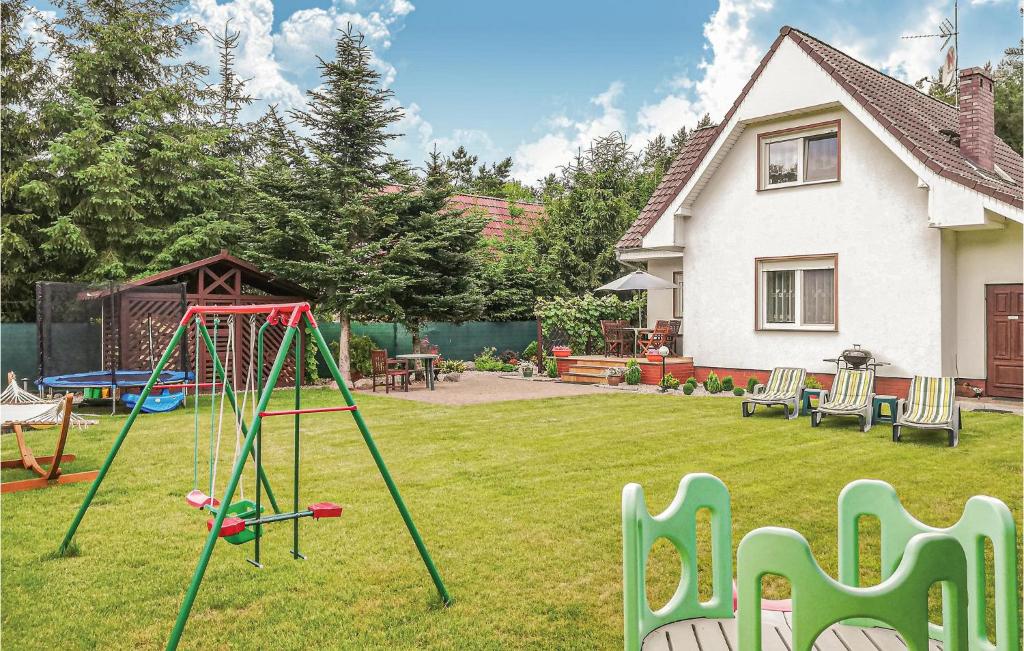 a yard with a playground with a swing at Stunning Home In Santoczno With 3 Bedrooms And Wifi in Santoczno