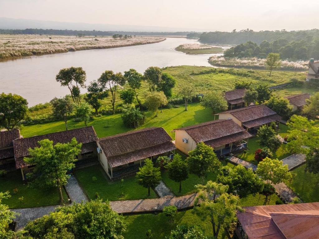 an aerial view of a village next to a river at Wild Adventure Resort in Sauraha