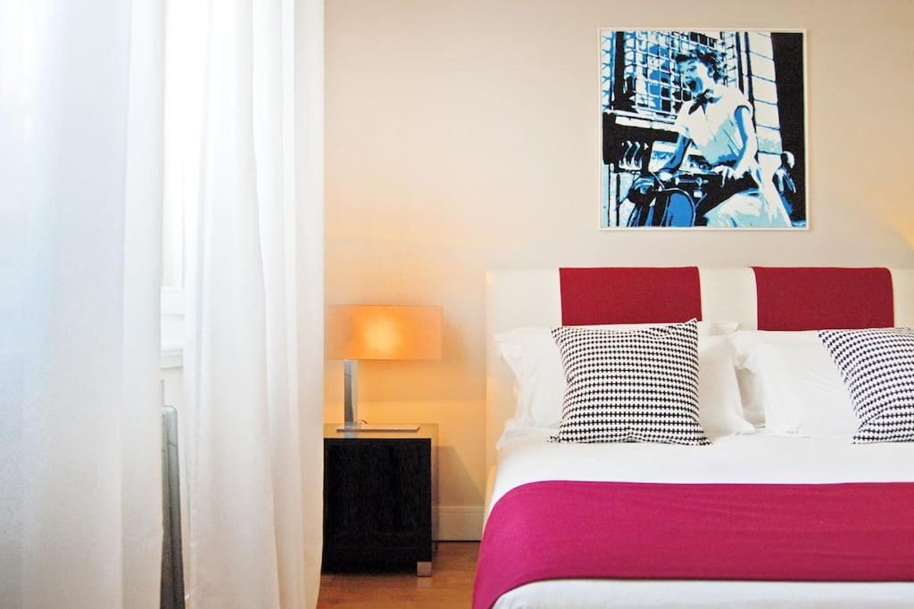 a bedroom with a red and white bed and a window at Pantheon Charming by Varental in Rome