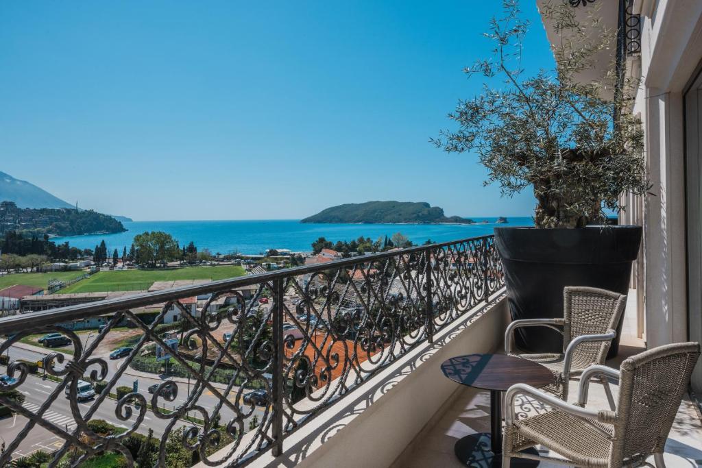 a balcony with chairs and a view of the ocean at Iberostar Waves Slavija in Budva