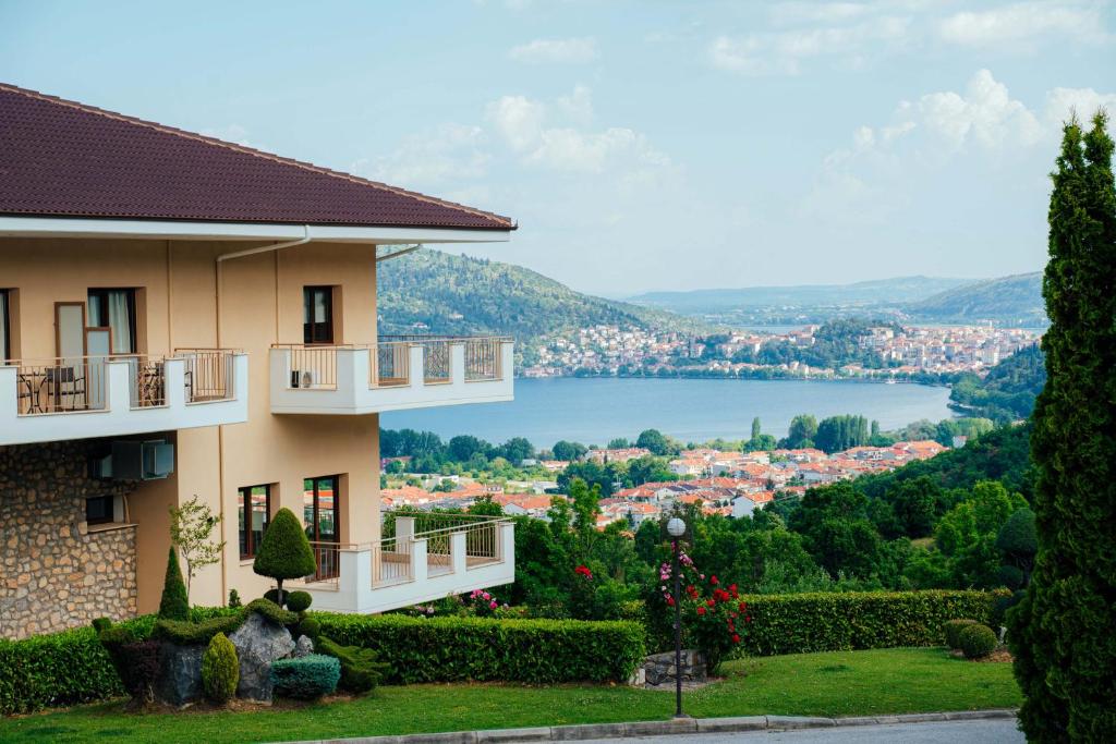 a building with a view of a city and a lake at Enastron View Hotel in Kastoria