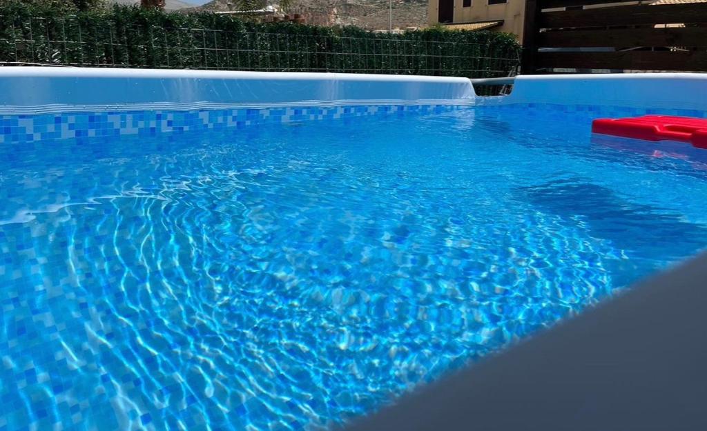 una gran piscina azul con agua azul en La Pergola en Custonaci