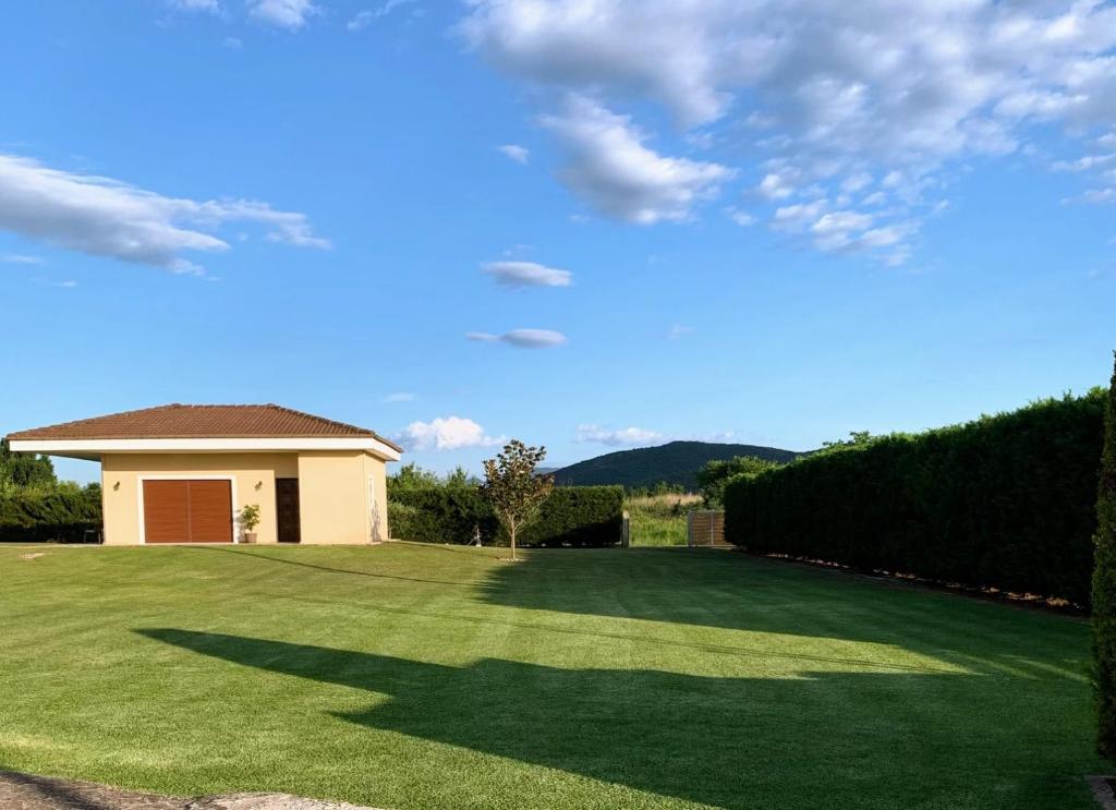 a house with a large yard with a green lawn at Galini Estate in Karditsa