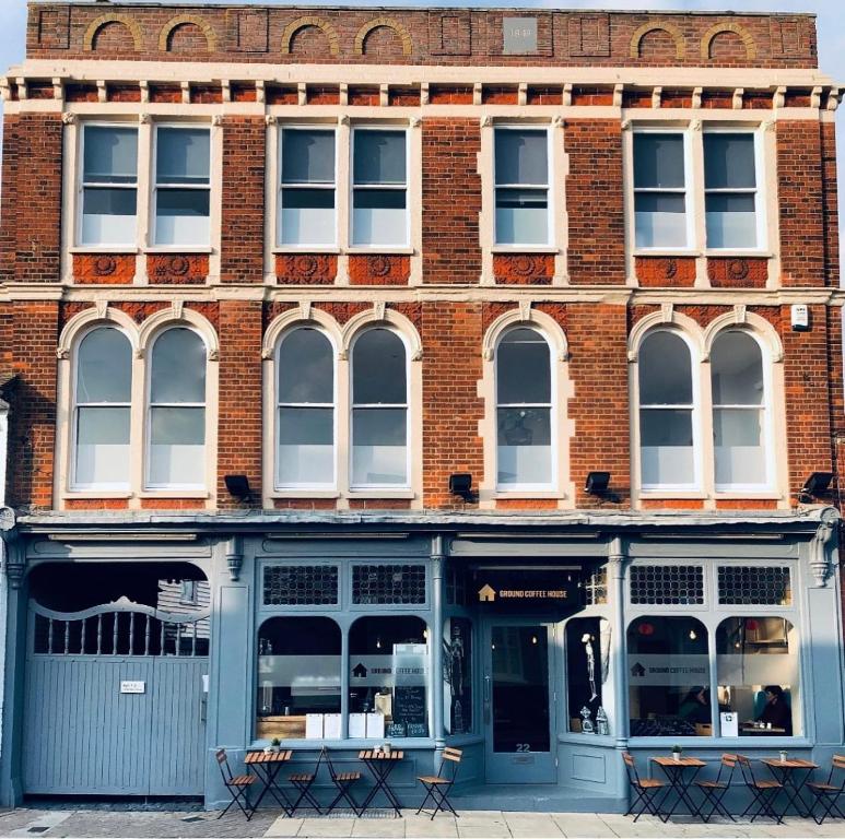 a brick building with blue doors and windows at Temperance House in Burnham-on-Crouch