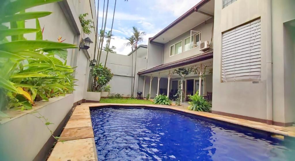 a swimming pool in the backyard of a house at Kemang Utara Creative Villas in Jakarta