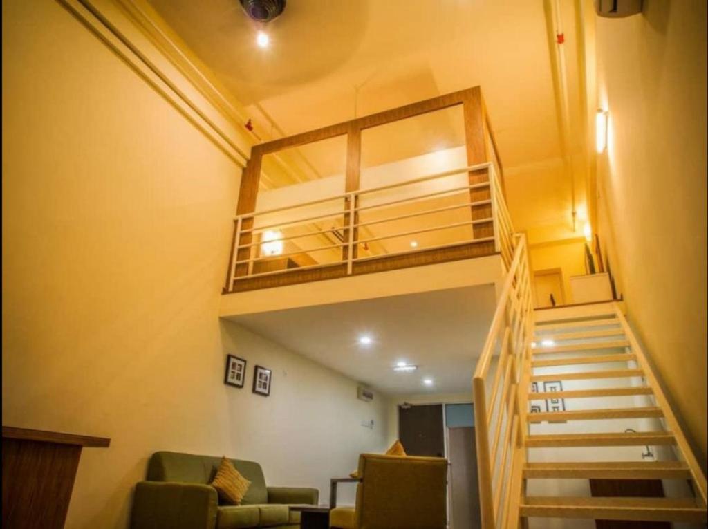 a room with a staircase with a bunk bed at The CEO Executive Suites in Bayan Lepas