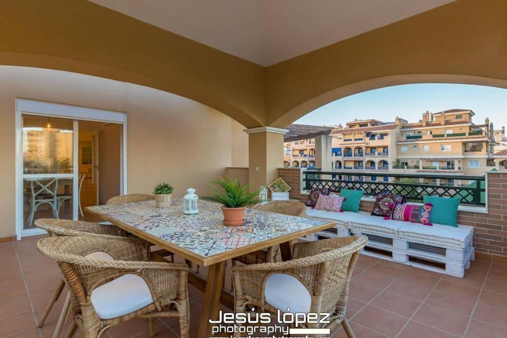 a patio with a table and chairs on a balcony at Apartamento Calma Beach Home in Torremolinos