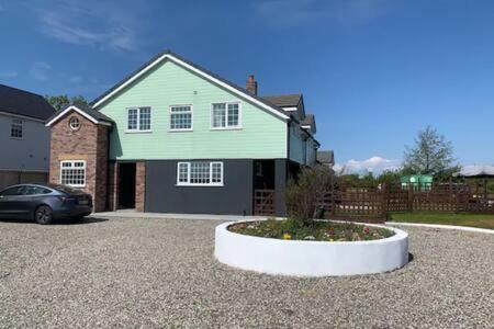 a house with a car parked in a driveway at Ranch House in Preesall