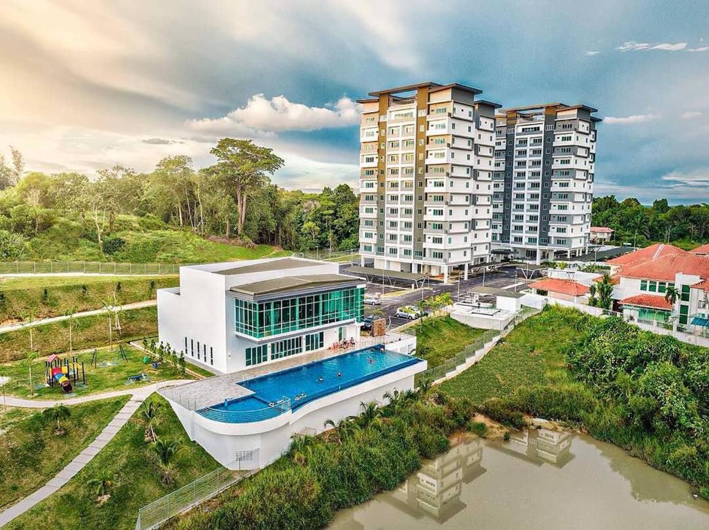 an aerial view of a building with a swimming pool at Serene Heights by Evernent in Miri