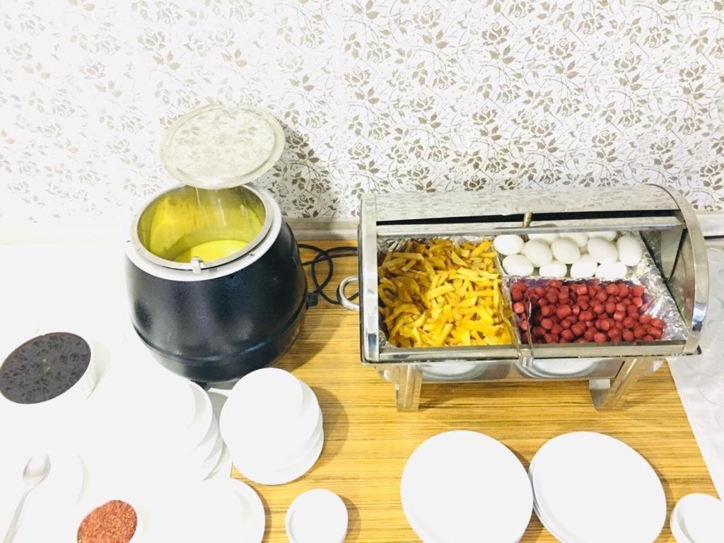 una mesa cubierta con un recipiente de alimentos y huevos en Grand Black Hotel, en Mersin