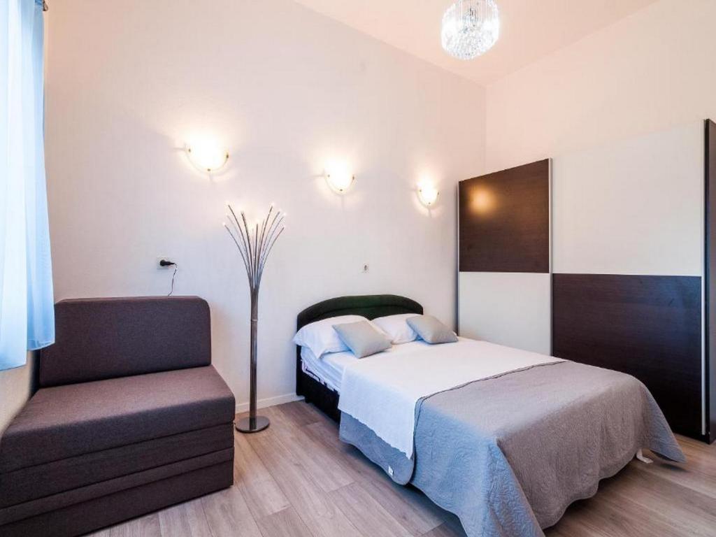 Posteľ alebo postele v izbe v ubytovaní Angelo's Apartments