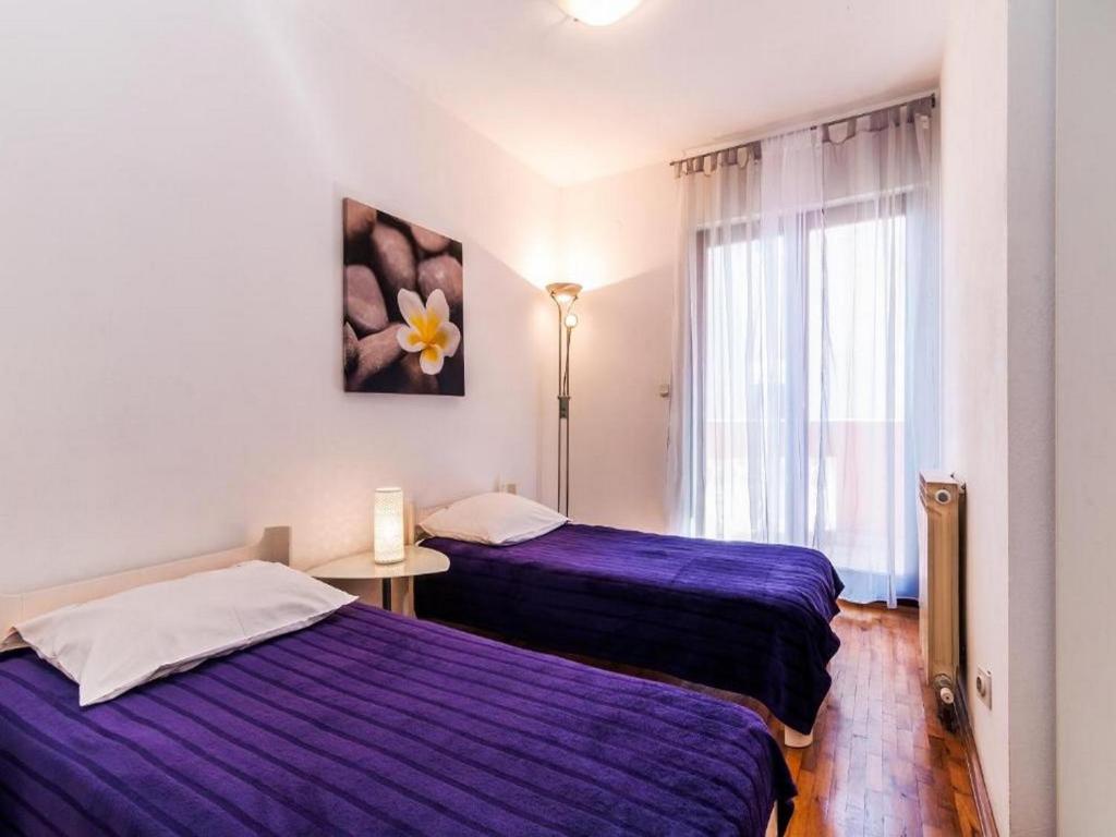 Posteľ alebo postele v izbe v ubytovaní Angelo's Apartments