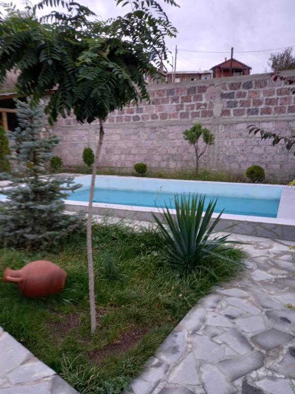 a small tree in a yard next to a pool at Villa Maria Dilijan in Dilijan