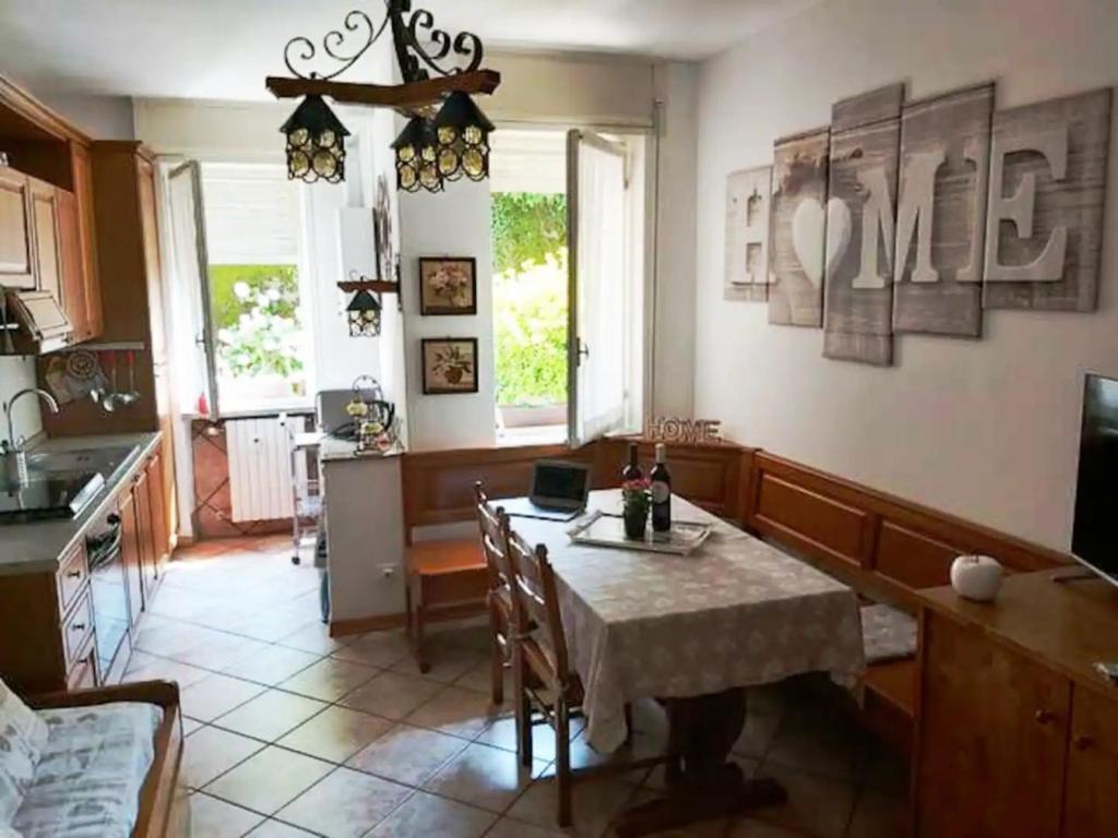 a kitchen with a table with a laptop on it at Casa Lù in Abbadia Lariana