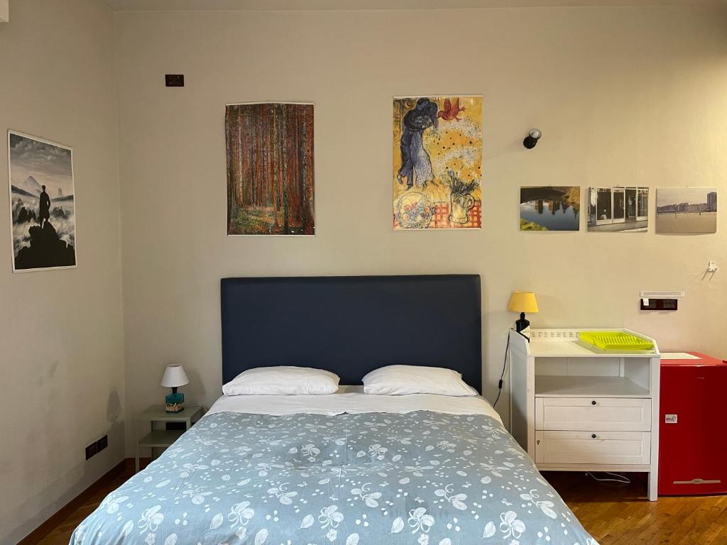 a bedroom with a bed and a desk and some pictures at Santo Spirito in Arezzo