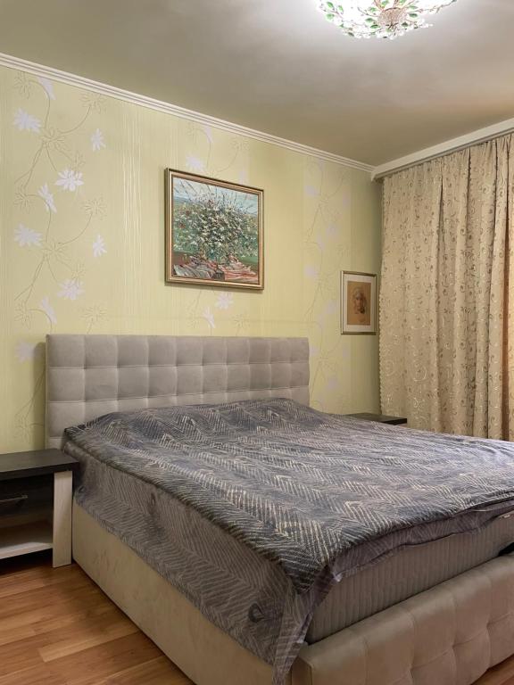 a bedroom with a large bed in a room at Boryspil Airport Luxury apartment in Boryspilʼ