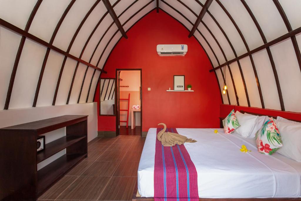 Postel nebo postele na pokoji v ubytování Kidi's Lodge Gilitrawangan