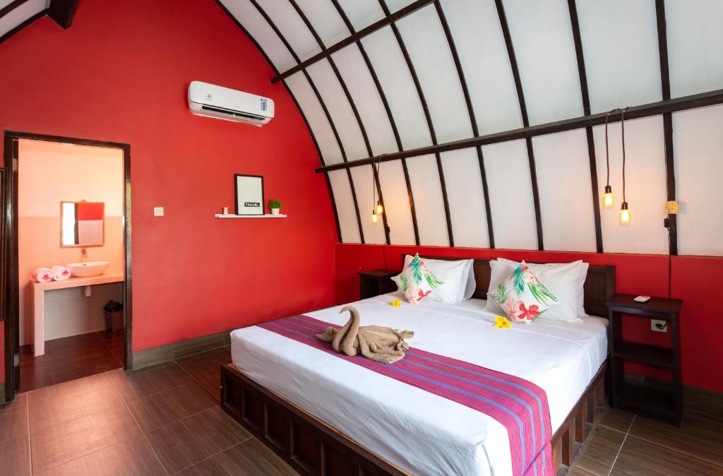 Postel nebo postele na pokoji v ubytování Kidi's Lodge Gilitrawangan