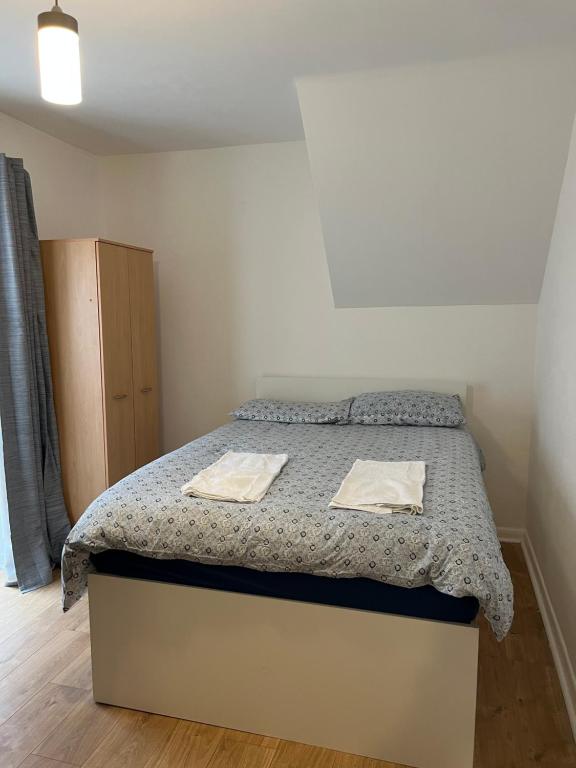 a bedroom with a bed with two towels on it at Midland road studio in Wellingborough