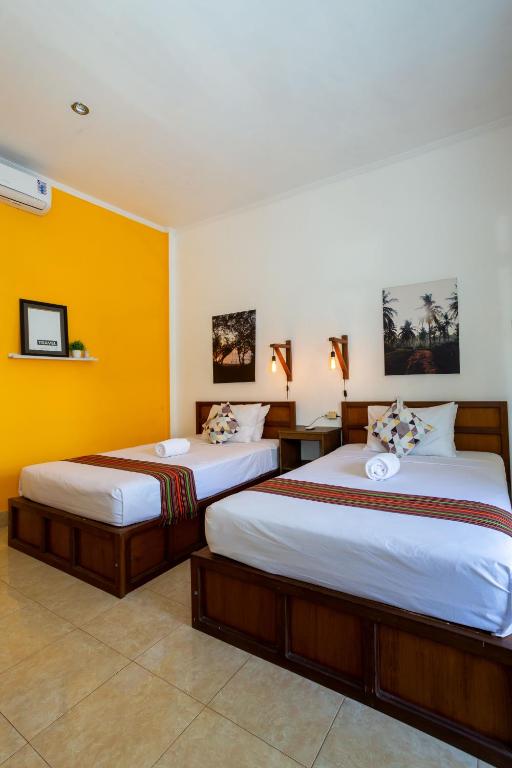 Postel nebo postele na pokoji v ubytování Kidi's Lodge Gilitrawangan