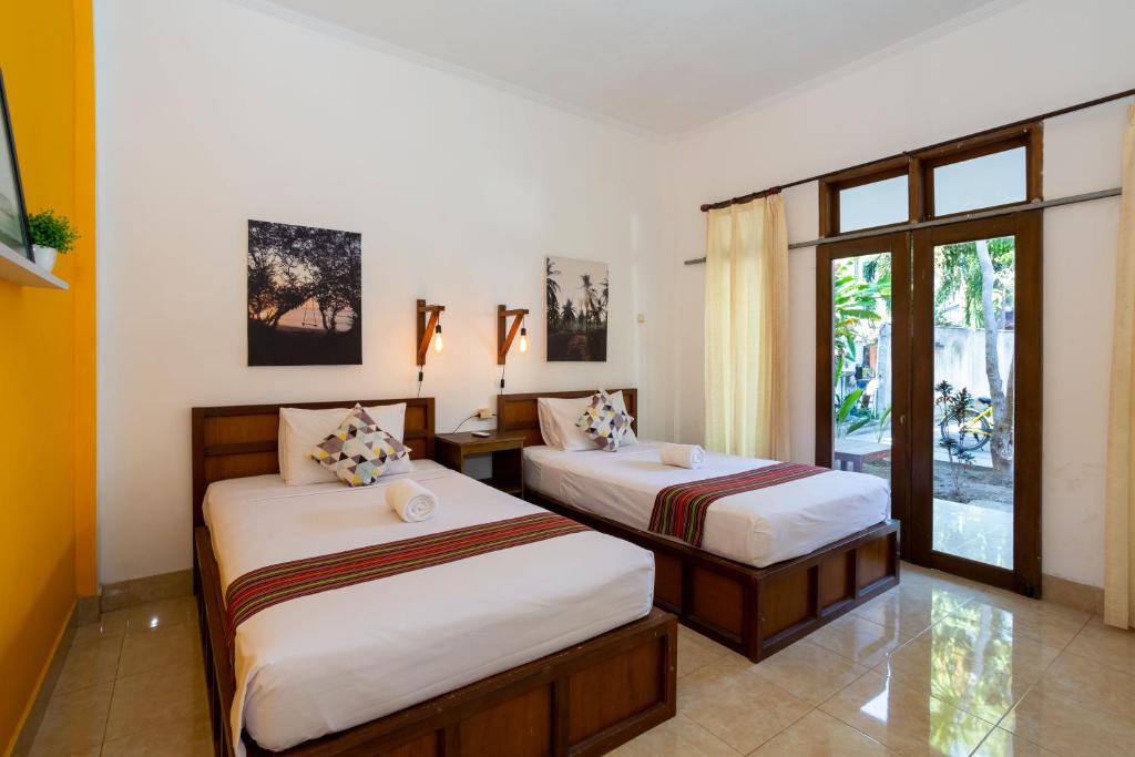 Postel nebo postele na pokoji v ubytování Kidi's Lodge Gilitrawangan