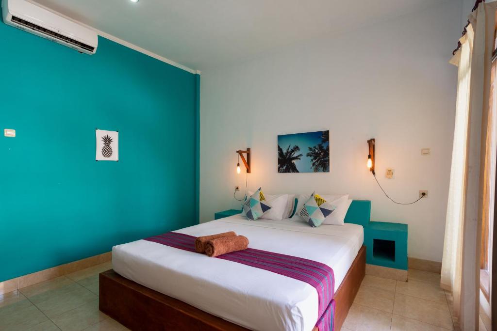 Postel nebo postele na pokoji v ubytování Kidi's Lodge Gilitrawangan