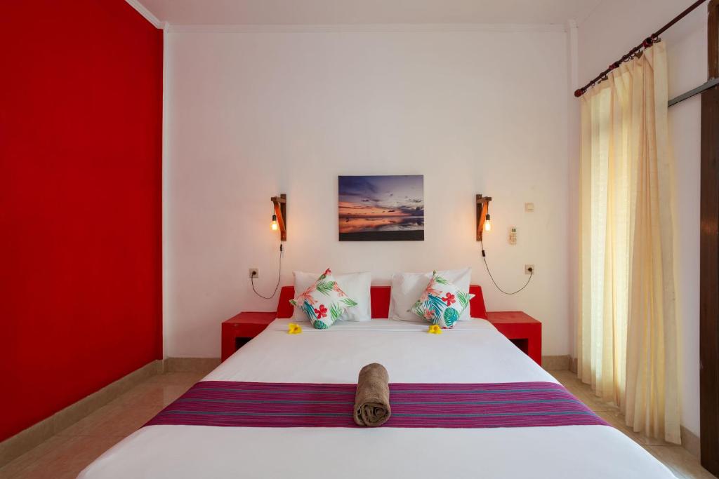 Postel nebo postele na pokoji v ubytování Kidi's Lodge Gilitrawangan